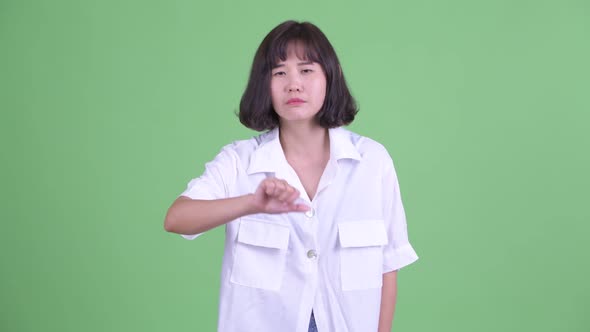 Sad Asian Businesswoman Giving Thumbs Down