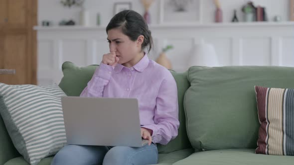 Indian Woman with Laptop Coughing on Sofa