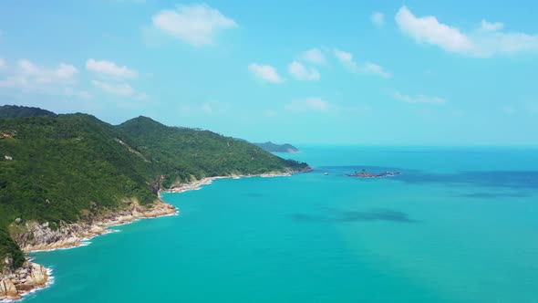 Aerial drone shot sky of marine lagoon beach break by blue ocean with clean sandy background of a da