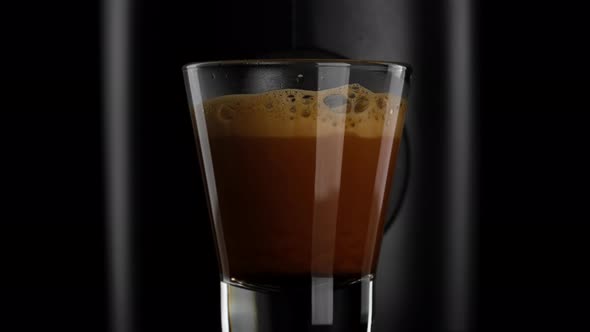 Black coffee with froth. Making black coffee espresso or ristretto in coffee machine