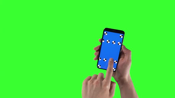 Man Holds Smartphone with Tracking Markers on Display and Swipes Left Then Right on Green Screen