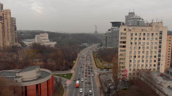 Drone Flies Over a Road with Cars and trucks.Aerial View of Highway Road with Moving Cars at Evening