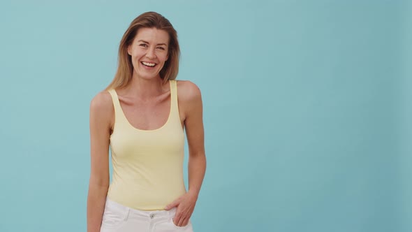 Pretty Model with One Hand on Her White Jeans Laughing