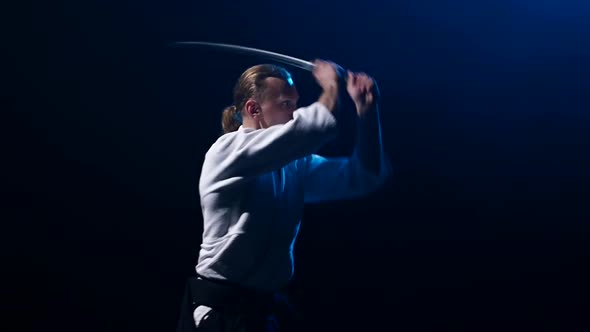Man Fighting at Aikido Training with Japanese Sword Katana in Martial Arts School. Healthy Lifestyle