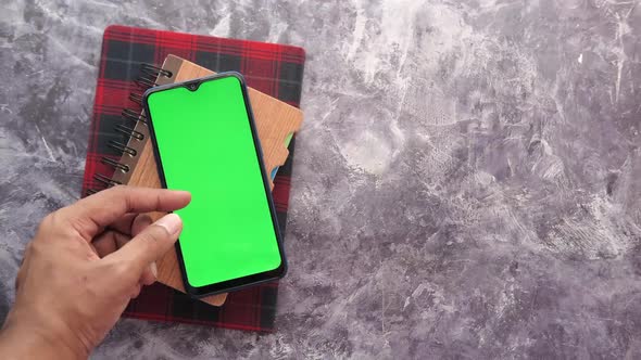 Top View of Man Hand Using Smart Phone on Black Background