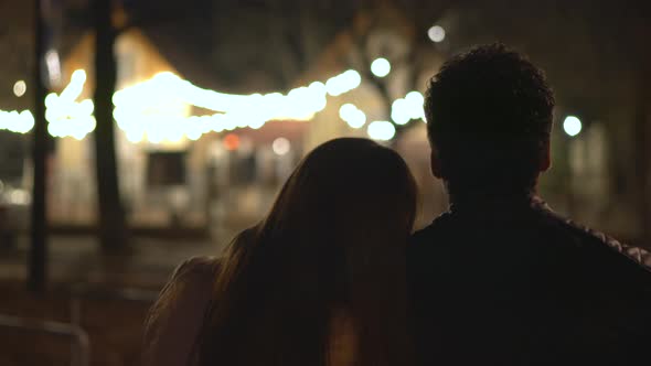 Rear view of a couple relaxing at night alt