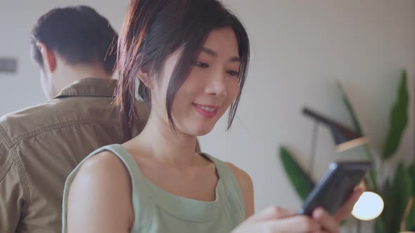 close up young asian female woman enjoy social media with smarttphone