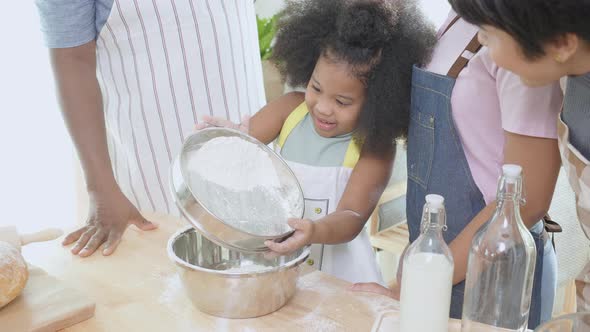 African America family wearing apron for cooking bakery or bread with flour together in the kitchen.