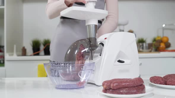 Making Raw Mincemeat with Meat Mincer at Home. Pile of Chopped Meat. Electric Mincer Machine with