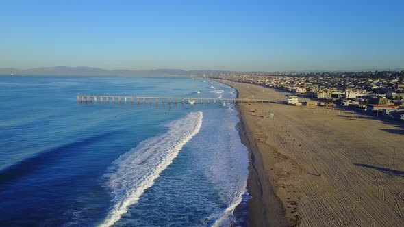 Aerial drone uav view of a pier over the beach and ocean.