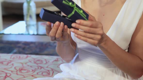 Woman looking at pendant she has receieved as a gift