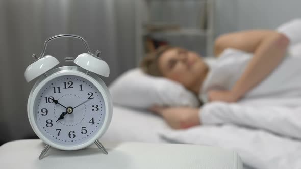 Female Waking Up Easily to Ringing Alarm Clock in Morning Healthy Lifestyle