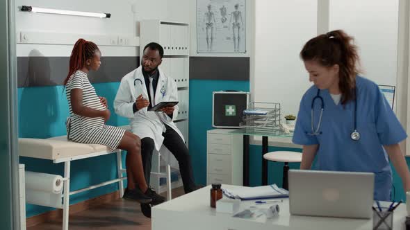 People Meeting in Medical Office to Talk About Pregnancy