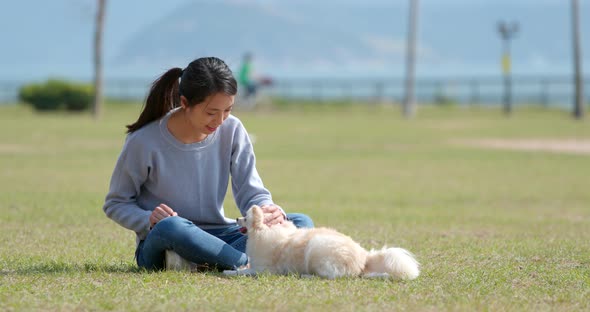 Woman playing with her dog at outdoor park