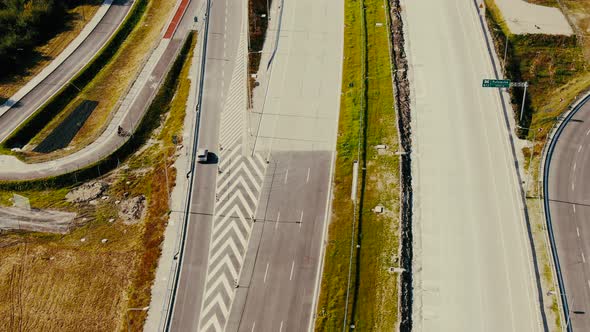 Drone shot highway motorway showing lanes with Tunnel and viaducts outside the city of Warsaw, Polan