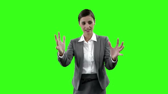 Businesswoman gesturing against green screen