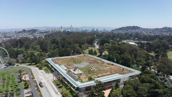 Descending aerial close-up shot of the California Academy of Sciences museum in Golden Gate Park, Sa