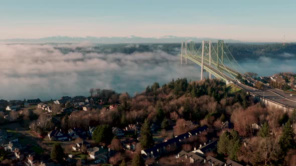 Fog rolls into and under the Tacoma Narrows Bridge in Puget Sound 4K UHD