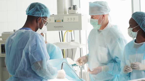 African and Caucasian Doctors Perform the Risky Surgery