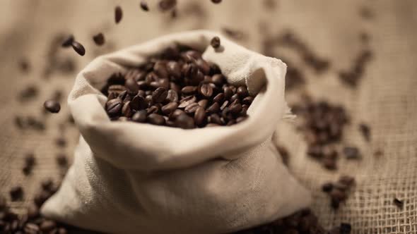 Coffee Beans are Falling on Burlap in Slow Motion