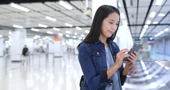 Woman use of mobile phone in station 