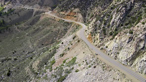 Aerial of a road through a mountain pass in California