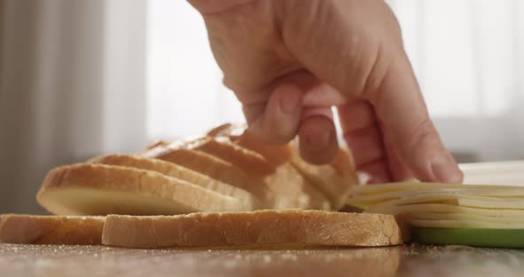 Making Bread With Cheese Sandwich At The Table In The Kitchen