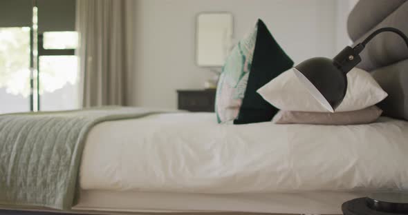 Close up of bed and lamp in luxury bedroom