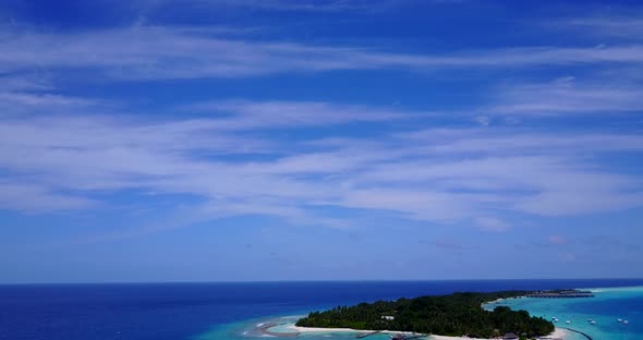 Luxury drone island view of a white sand paradise beach and aqua blue ocean background