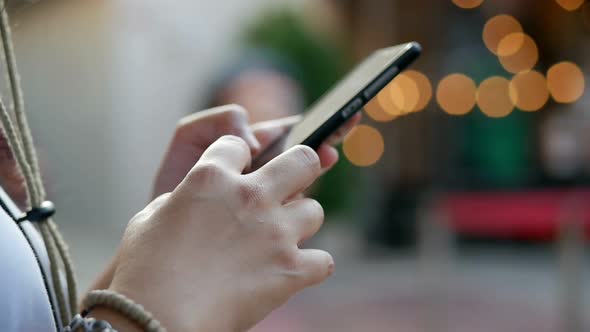 Close up Asian woman hand using a smartphone.