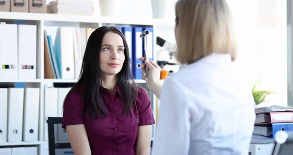 Woman Patient Following with Her Eyes Movements of Percussion Hammer of Neurologist Movie Slow