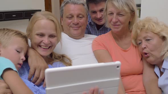 Big Family Watching Video on Digital Tablet