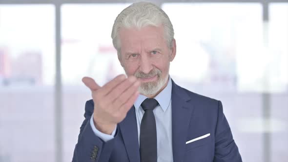 Inviting Old Businessman Pointing Finger at Camera