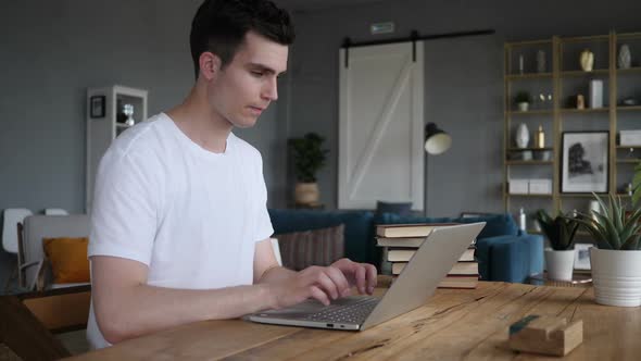 Shocked Stunned Man Wondering and Working on Laptop