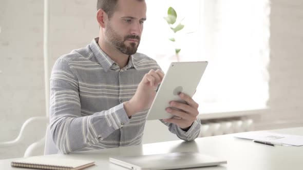 Adult Young Man Using Digital Tablet