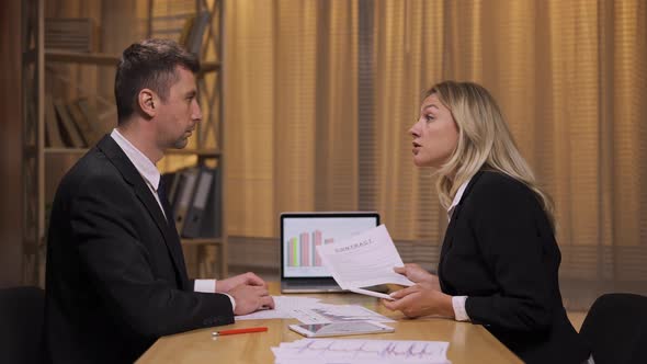 Business Partners Analyze Stock Market and Team Strategy in an Office Meeting