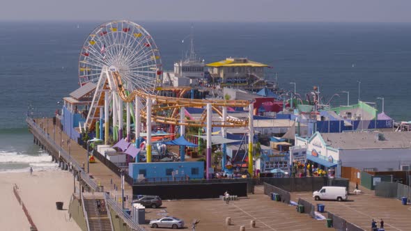 Aerial of Ferris wheel and amusement park rides at Pacific Park