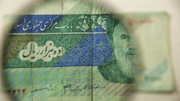 Ten thousand Iranian rials and a magnifying glass.