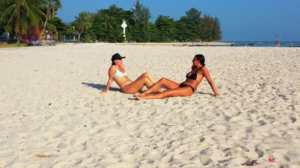 Ladies best friends on relaxing tourist beach time by blue lagoon and clean sand background of Thail