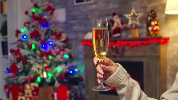 Young Woman Holding Sparkling Champagne Celebrating Christmas