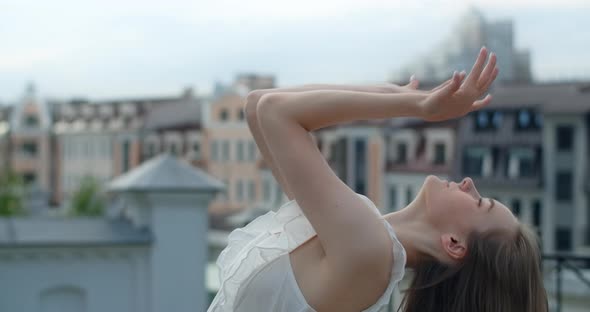 Portrait of the Woman Dancer in White Dress That Dances Gracefully in Slow Motion Outdoors Balerina