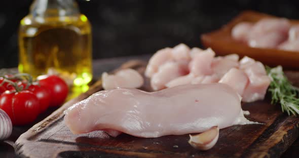 Raw Chicken Fillet with Garlic and Tomatoes Slowly Rotates. 