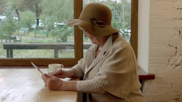 Woman with Tablet Drinking Coffee