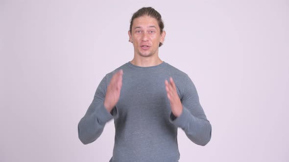 Handsome Man Presenting Something Against White Background