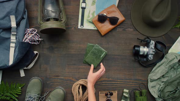 Top View of Hand Putting Passports Down on Table