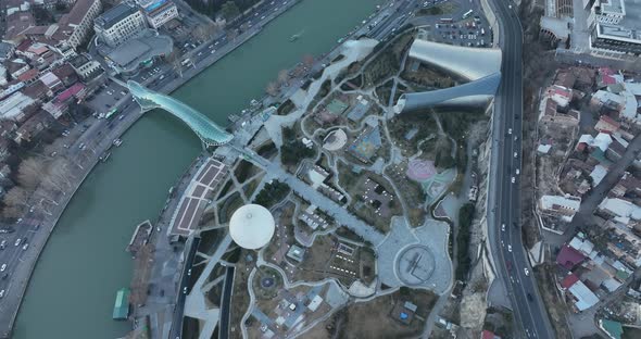 Aerial view of Tbilisi city central park and Bridge of Peace. Beautiful cityscape of old Tbilisi