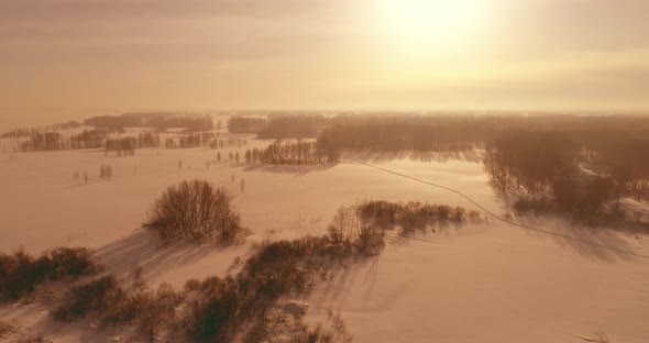 Aerial View of Cold Winter Landscape Arctic Field Trees Covered with Frost Snow Ice River and Sun