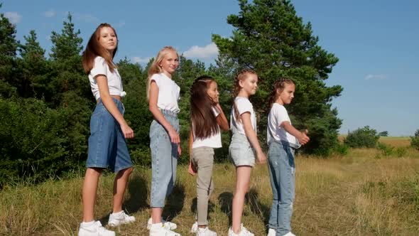 Five Girls Outdoors Showing Thumbs Up