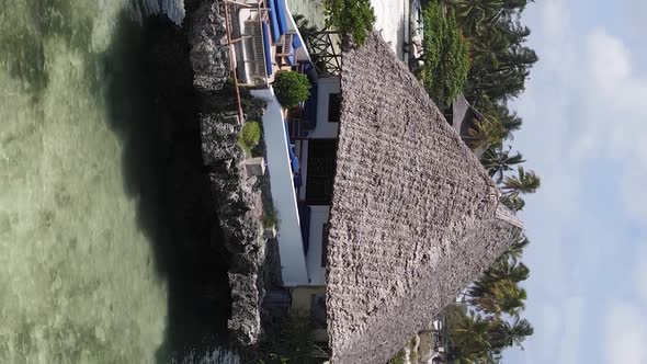 Vertical Video House on Stilts in the Ocean on the Coast of Zanzibar Tanzania Aerial View