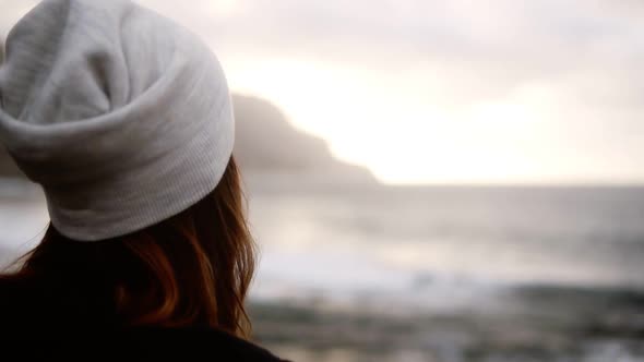 Portrait of Pretty Woman in Hat Red Plaid Coat Enjoying Time By the Seaside on a Cloudy Day Standing